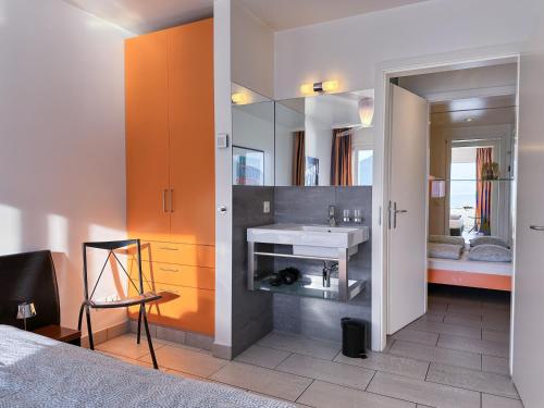 a bathroom with a sink and a mirror at Residenza Acapulco I by Fewotessin in Moscia