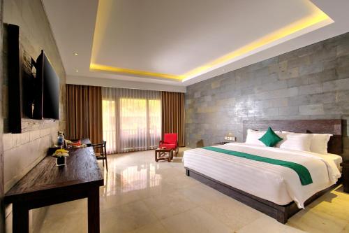 a bedroom with a large bed and a television at The Westlake Hotel & Resort Yogyakarta in Yogyakarta