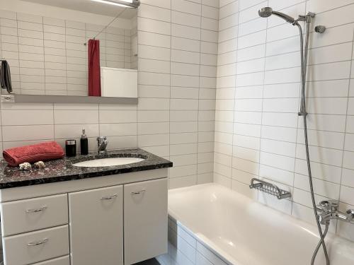 a bathroom with a white tub and a sink at Residenza Acapulco II by Fewotessin in Moscia
