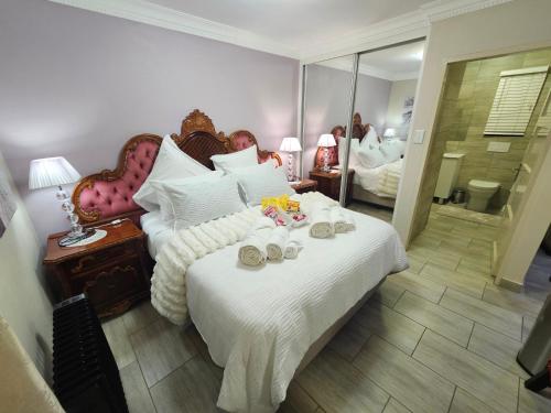 a bedroom with a large bed with shoes on it at A Pearl Place in Pretoria