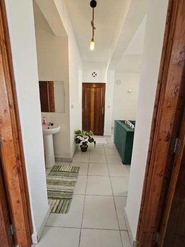 a hallway of a house with a sink and a mirror at SuCasa Homes in Mombasa