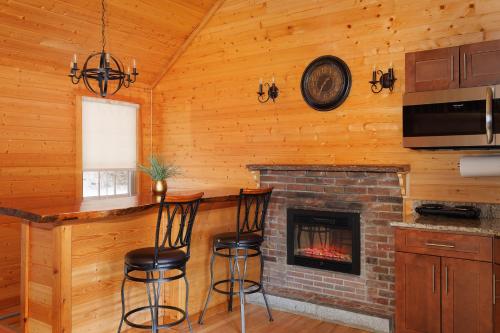 a bar in a log cabin with a fireplace at Presidential Mountain Resort in Bethlehem