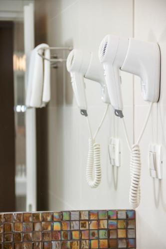 two hair dryers hanging on a wall in a bathroom at Prima Luxury Rooms in Split