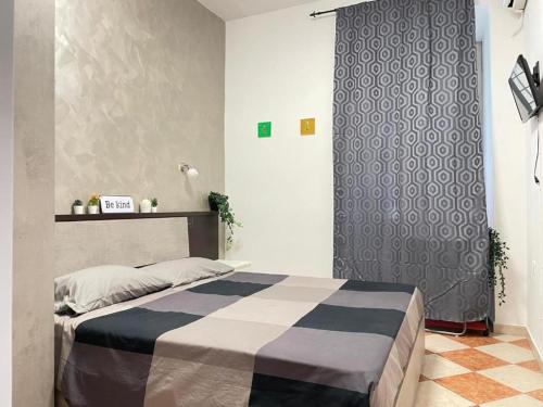 a bedroom with a bed with a blue and white blanket at Residenza Abat-Jour de Rome in Rome