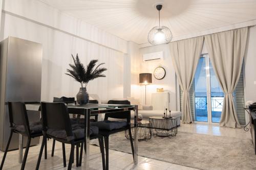 a dining room with a table and chairs in a room at Acropolis luxury home in Athens