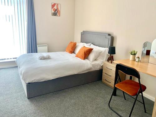 a bedroom with a bed with a desk and a chair at 1 Bed Apartment By Cozy Quarters Property Management Short Term Lets Hartlepool Near Beach in Hartlepool