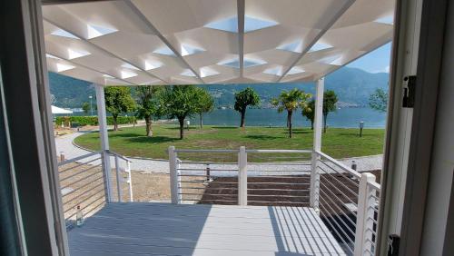 a porch with a view of the water and mountains at Belvedere Clusane Camping in Iseo
