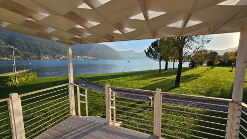 a porch of a house with a view of the water at Belvedere Clusane Camping in Iseo