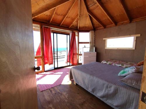 a bedroom with a bed and a view of the ocean at Casa La Virgen in Burro Muerto