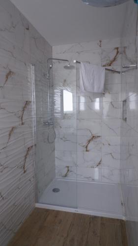 a bathroom with a shower with a glass door at Peprina Penthouse in Central Rabat in Rabat