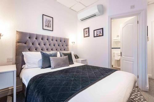 a bedroom with a large bed with a large headboard at The Melita in London