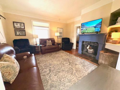 a living room with a couch and a fireplace at Garden City House with Hot Tub in Colorado Springs