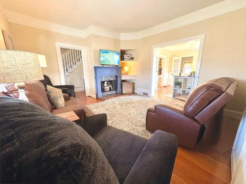 a living room with a couch and a fireplace at Garden City House with Hot Tub in Colorado Springs