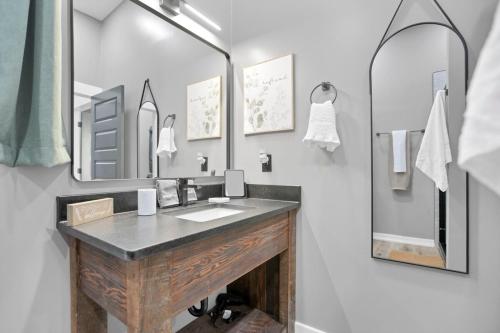 a bathroom with a sink and a mirror at Pine Grove Barndominium in Sugar Grove