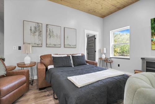 a bedroom with a bed and a couch at Pine Grove Barndominium in Sugar Grove