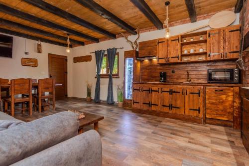 a living room with a couch and a table at Villa Nancy with jacuzzi in Benkovac