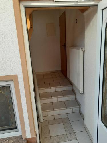 a small hallway with stairs leading to a door at Appartment Annika in Hochheim