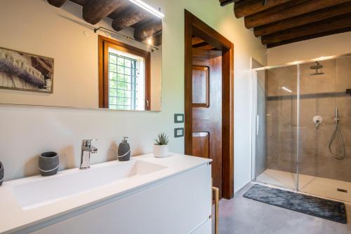 a bathroom with a sink and a shower at Il Salice Country Luxury in Due Carrare