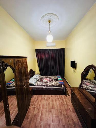 a room with two beds and a window at spacious ground floor apartment in Taroudant