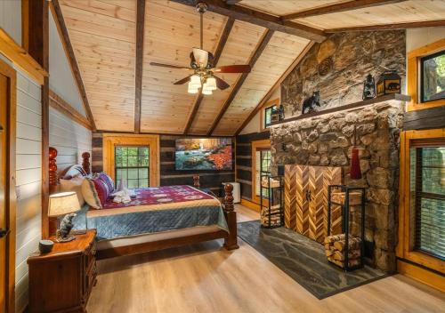 a bedroom in a log cabin with a stone wall at Rustic Lodge - Pet-Friendly Cabin with Hot Tub & Fire Pit in Pigeon Forge