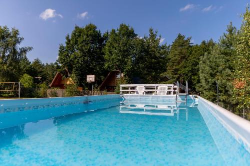 a swimming pool with a water slide at Słoneczna Przystań in Sasino