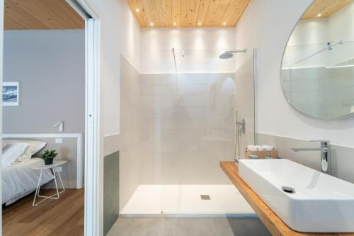 a bathroom with a sink and a shower at Le Vie del Borgo | 3 dimore indipendenti a Civita in Civita