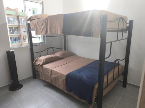 a bedroom with two bunk beds and a window at Balcones del Bosque 14 -402 in Restrepo