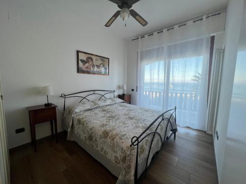a bedroom with a bed and a ceiling fan at B&B La Finestra sui Trabocchi in San Vito Chietino