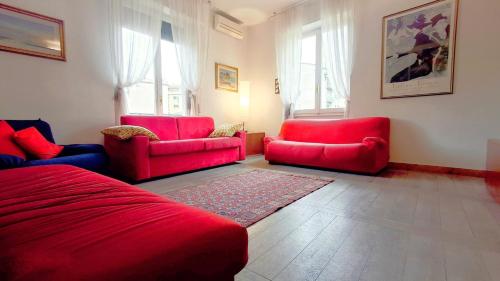 a living room with red chairs and a red couch at Cappuccini Florence your easy stay close to the center in Florence