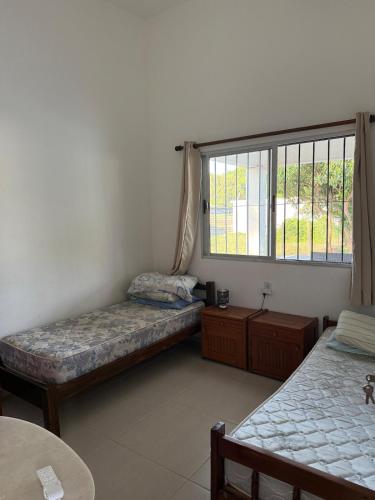 a room with two beds and a window at House in La Tuna in Balneario Argentino