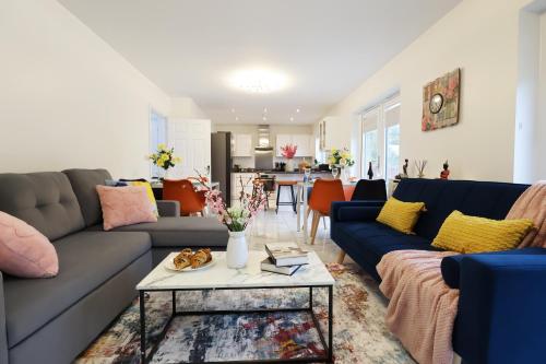 a living room with a couch and a table at 6 Bedroom Cardiff Stylist Home - 4 Free Private Parking - Ideal for Family & Contractors in Cardiff