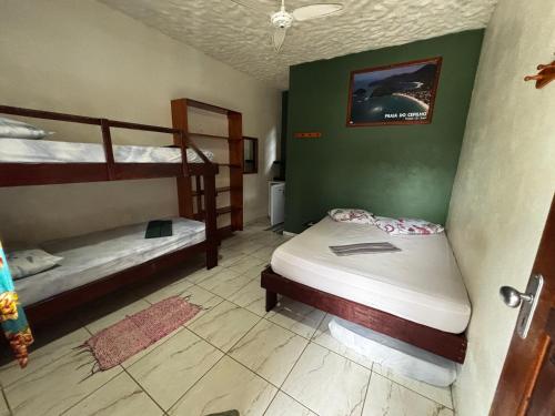 a bedroom with two bunk beds in a room at Pousada Figueira in Trindade