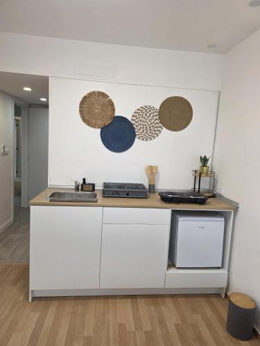 a kitchen with white cabinets and a counter top at Spa & Jacuzzi Dupla Privada Escapadinha Romântica Abrantes in Abrantes