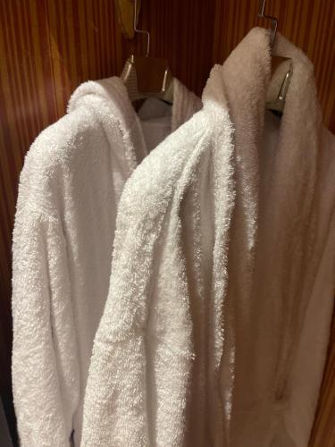 two white towels hanging on a rack in a bathroom at شقه فندقيهTv75-PS4حدايق الاهراماتPyramids in ‘Ezbet `Abd el-Ḥamîd