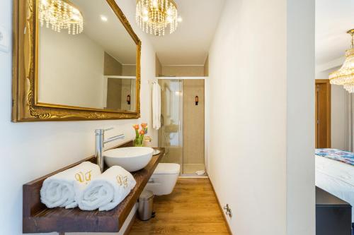a bathroom with a sink and a mirror at Vale da Fonte - Charming Houses in Ponte da Barca