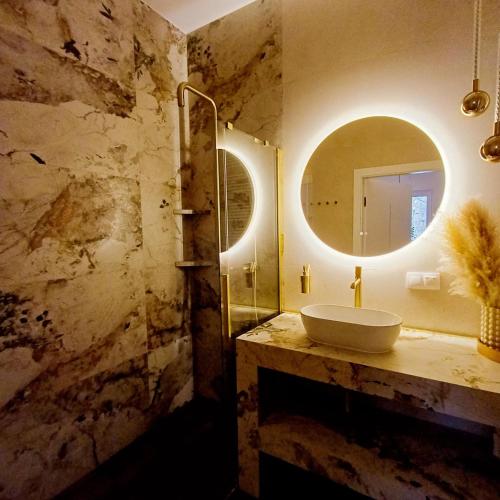 a bathroom with a sink and a mirror at Apartament Eleven Międzyzdroje in Międzyzdroje