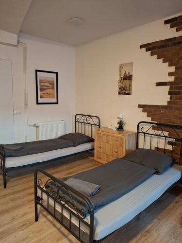 a room with two beds and a staircase at U Tomáška in Malá Morávka