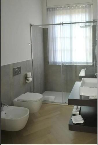 a bathroom with a toilet and a sink and a shower at Urban Stay Siena in Siena