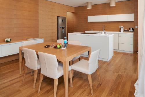 a kitchen and dining room with a wooden table and chairs at D-Resort Šibenik in Šibenik