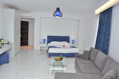 a living room with a couch and a bed at Zorbas Beach Hotel in Tigaki