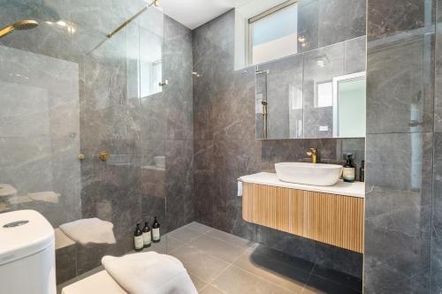 a bathroom with a sink and a shower at Modern refine home in Bellerive