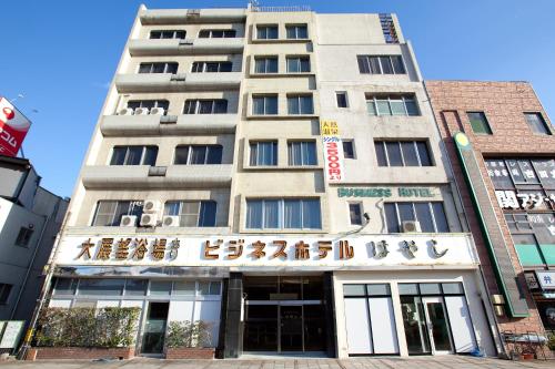 a tall building with a sign on it at Hotel Hayashi in Beppu