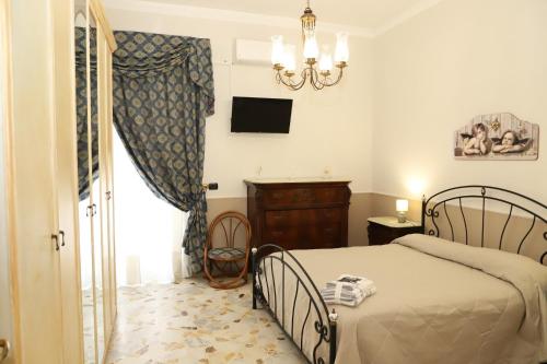 a bedroom with a bed and a chandelier at Paradiso dell'Etna in Zafferana Etnea