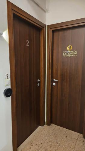 a wooden door with a sign on it in a room at AURY HOUSE -HistoricCenter- in Cremona