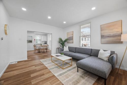 a living room with a couch and a table at Pittsburgh Spacious and Modern Three Bedroom Apartment with Free Parking in Pittsburgh