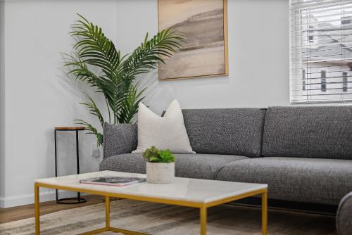 a living room with a couch and a coffee table at Pittsburgh Spacious and Modern Three Bedroom Apartment with Free Parking in Pittsburgh