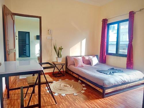 a living room with a couch and a window at The Himalayan Homes in Tokna
