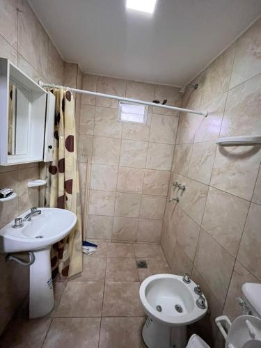 a bathroom with a sink and a toilet at Edificio LUMARO in San Fernando del Valle de Catamarca