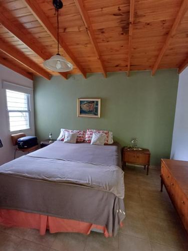 a bedroom with a bed and a wooden ceiling at Las Guardia in Cortaderas