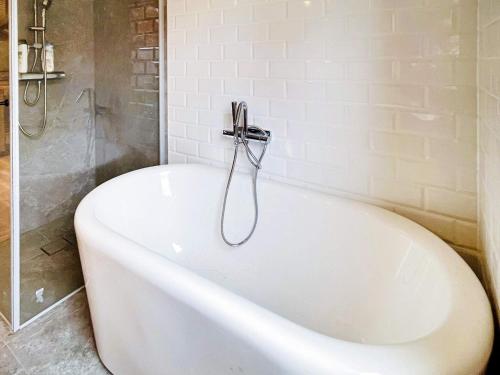 a white bath tub in a bathroom with a shower at 4 star holiday home in ONSALA-By Traum in Onsala